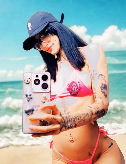 Swimwear on the beach, pink bikini and navy cap